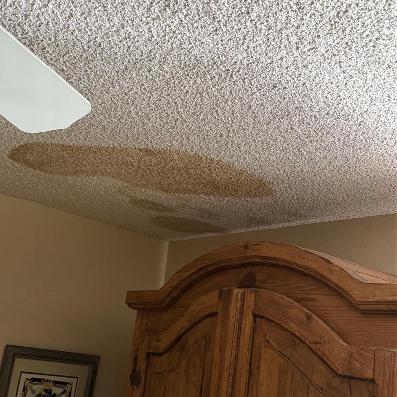 Popcorn ceiling water stains above wooden armoire Popcorn ceiling water stains above wooden armoire
