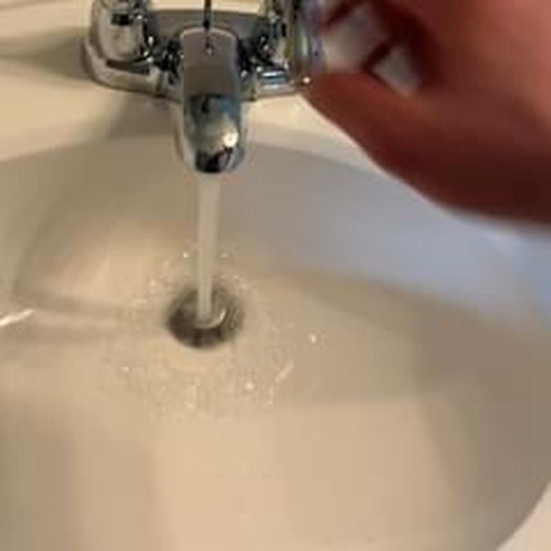 Bathroom sink pop-up drain with running water
