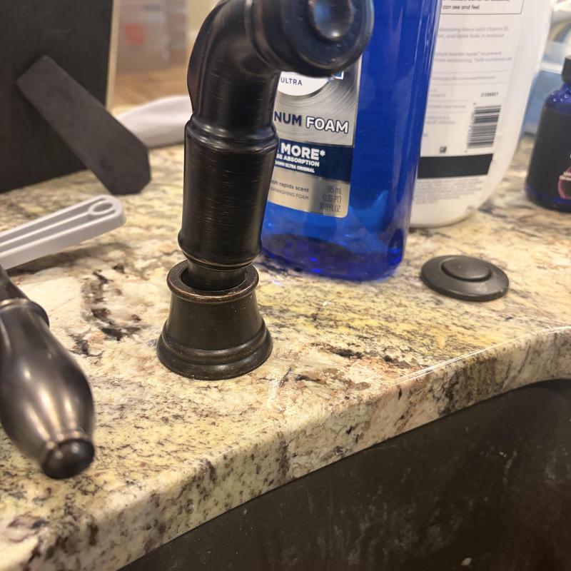 Kitchen faucet sprayer hose installation on granite countertop
