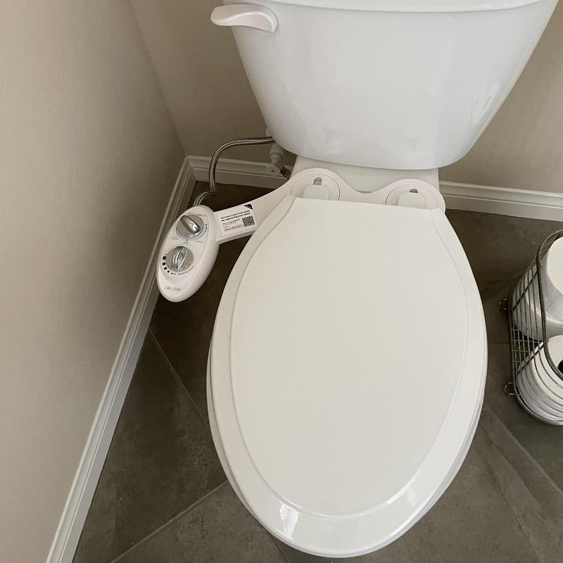 Bidet toilet seat with control knobs installed