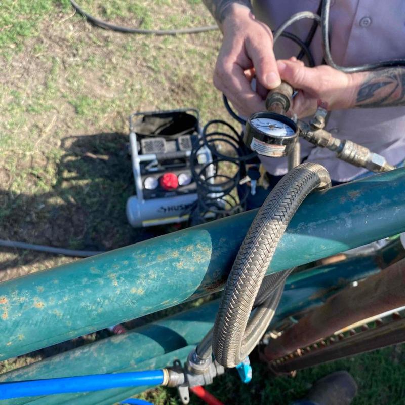 Water pressure gauge and hose on backyard piping system