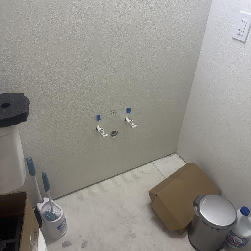 Wall-mounted toilet plumbing rough-in in bathroom remodel