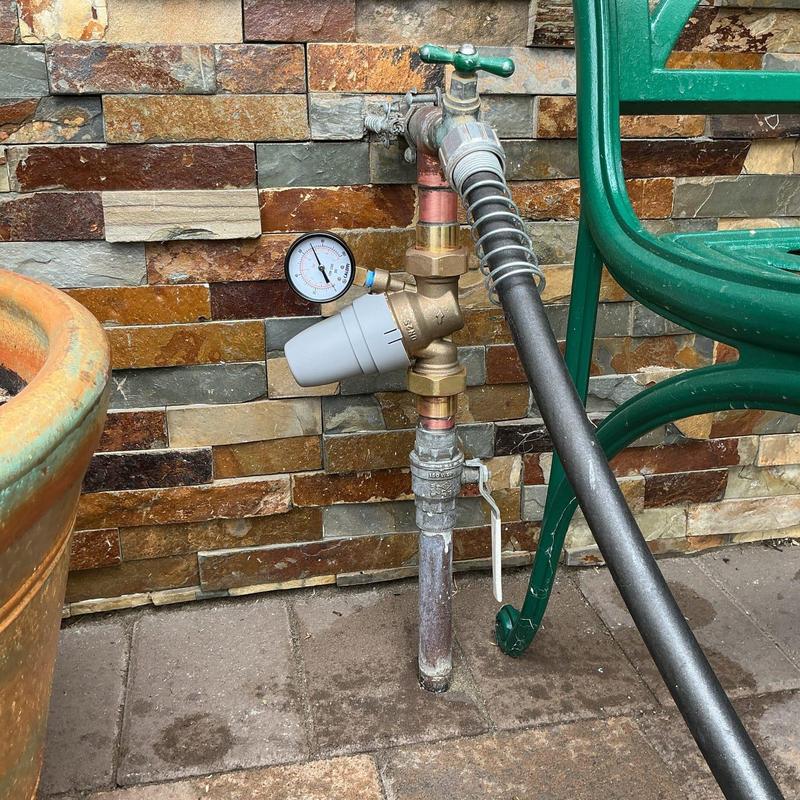 Pressure regulator with gauge and hose connection outdoors