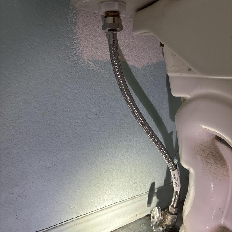 Toilet supply line installation under toilet tank