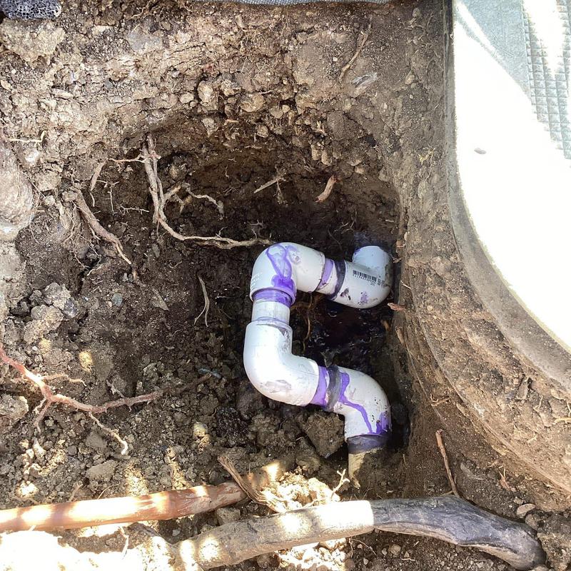 PVC water main with elbow fittings installed in soil