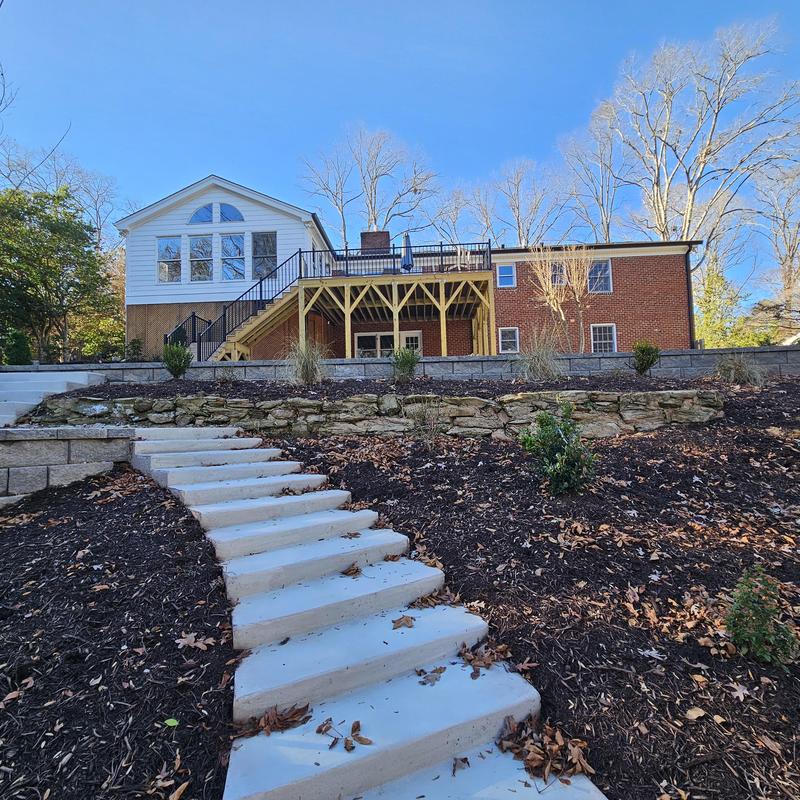 Concrete outdoor stairs with stone retaining wall and deck Concrete outdoor stairs with stone retaining wall and deck