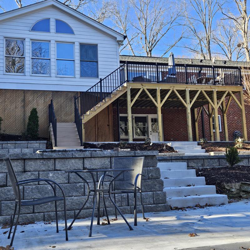 Wooden backyard deck with metal railing and stairs Wooden backyard deck with metal railing and stairs