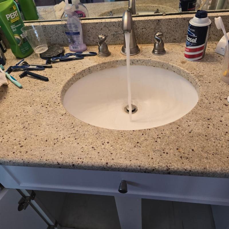 Bathroom sink drain clearing with running water