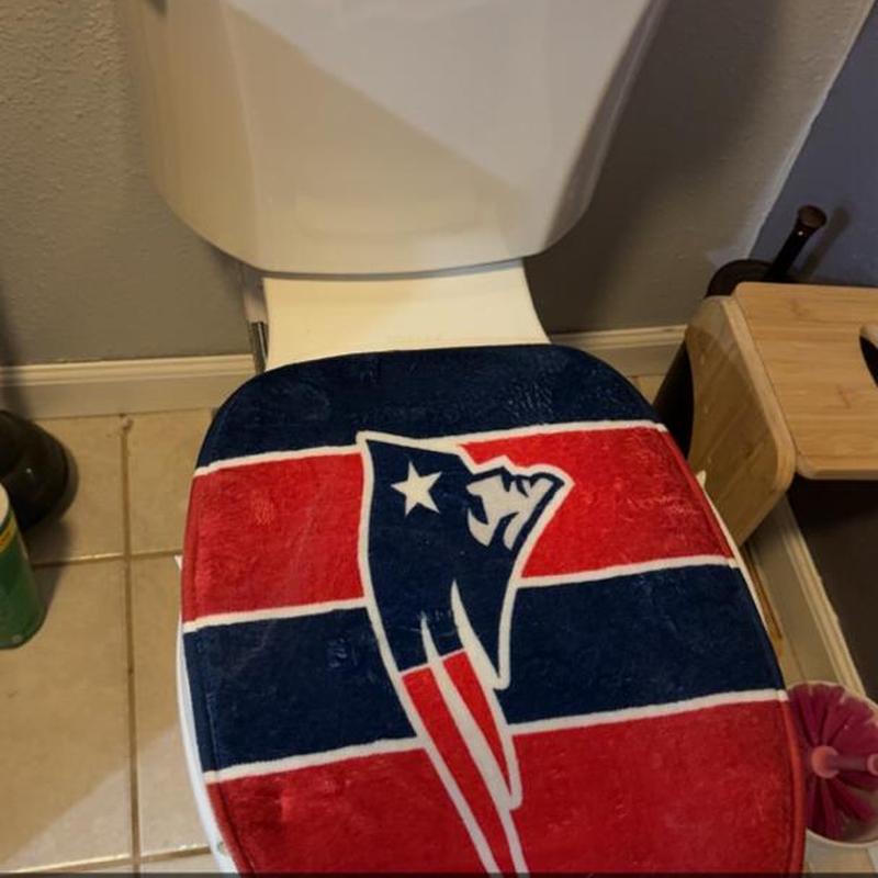 Toilet with Patriots-themed seat cover in bathroom Toilet with Patriots-themed seat cover in bathroom