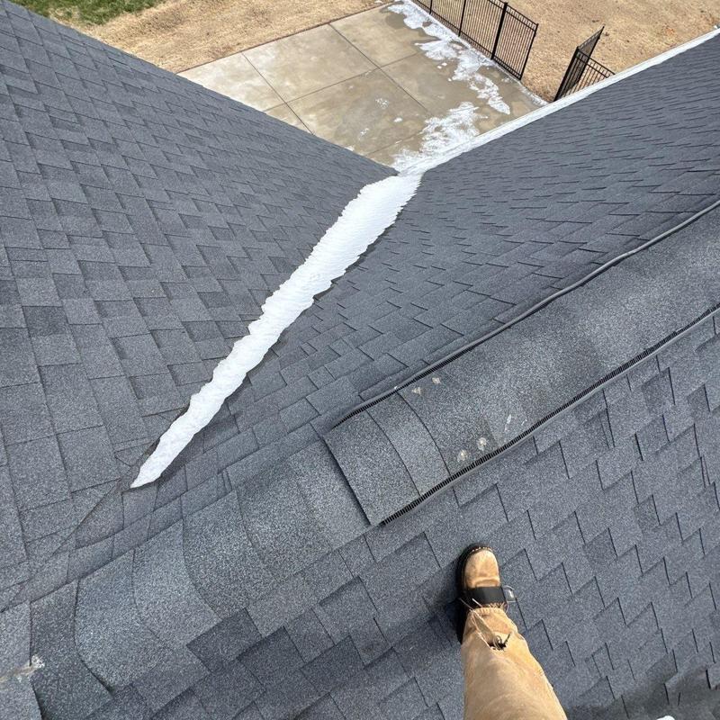 Asphalt shingle roof with ridge vent and snow patch