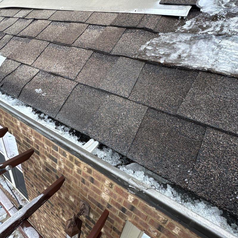 Asphalt shingles with hail damage and ice buildup
