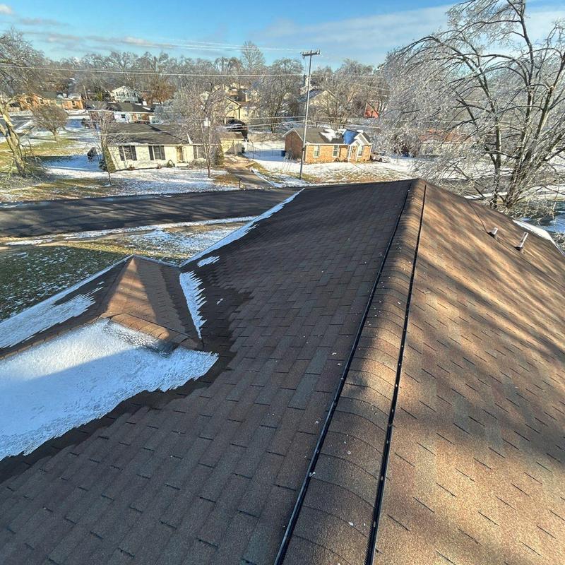 Asphalt shingle roof with hail damage and ice buildup