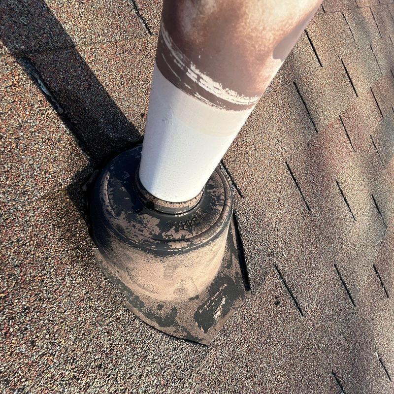 Roof vent flashing with wear on aging shingles