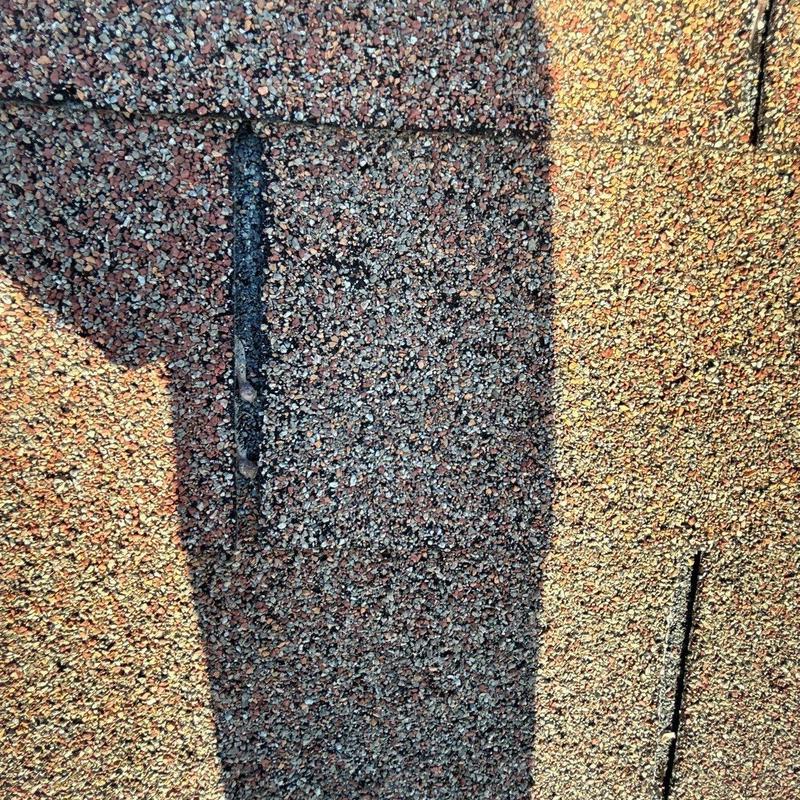 Roof shingles with hail damage and wear marks