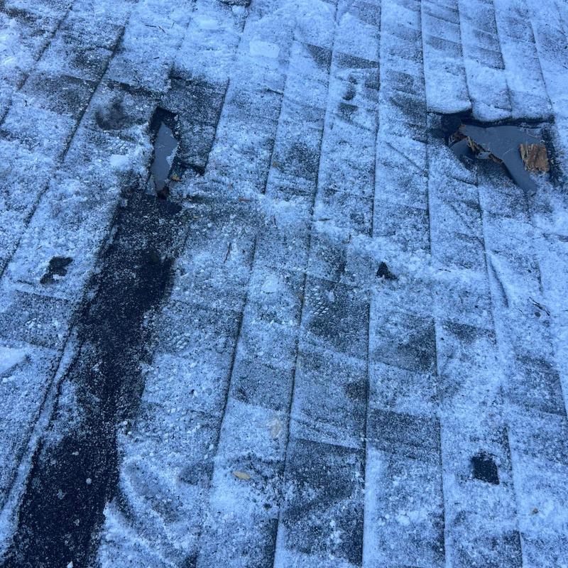 Asphalt shingle roof with hail damage and torn areas