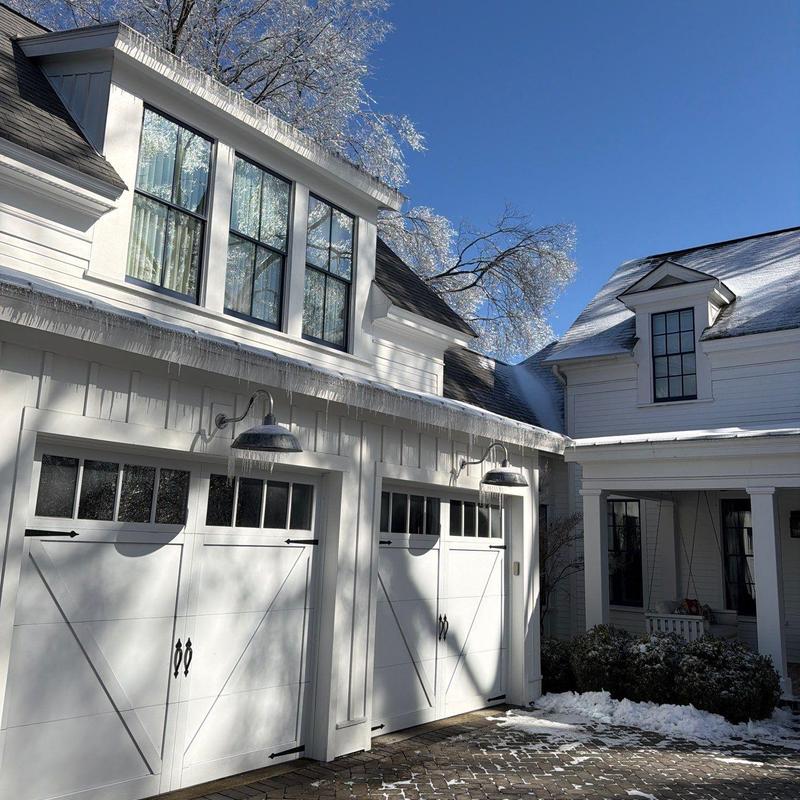 Roof shingles and gutters with ice buildup on house