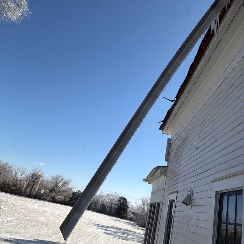 Roof gutter hanging loose from house side