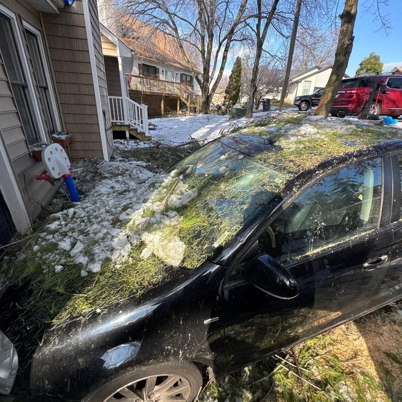 Car windshield with hail and debris damage after storm