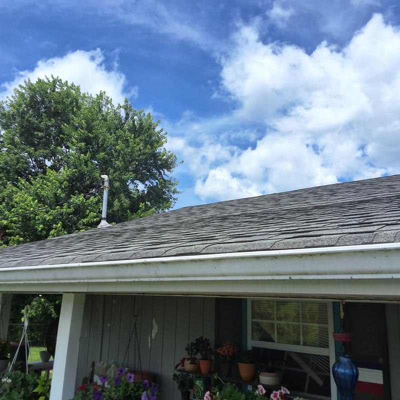 Shingles roof with visible aging and damage Shingles roof with visible aging and damage