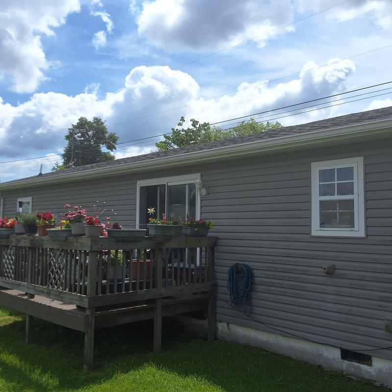 Shingles roof inspection with deck and siding visible Shingles roof inspection with deck and siding visible