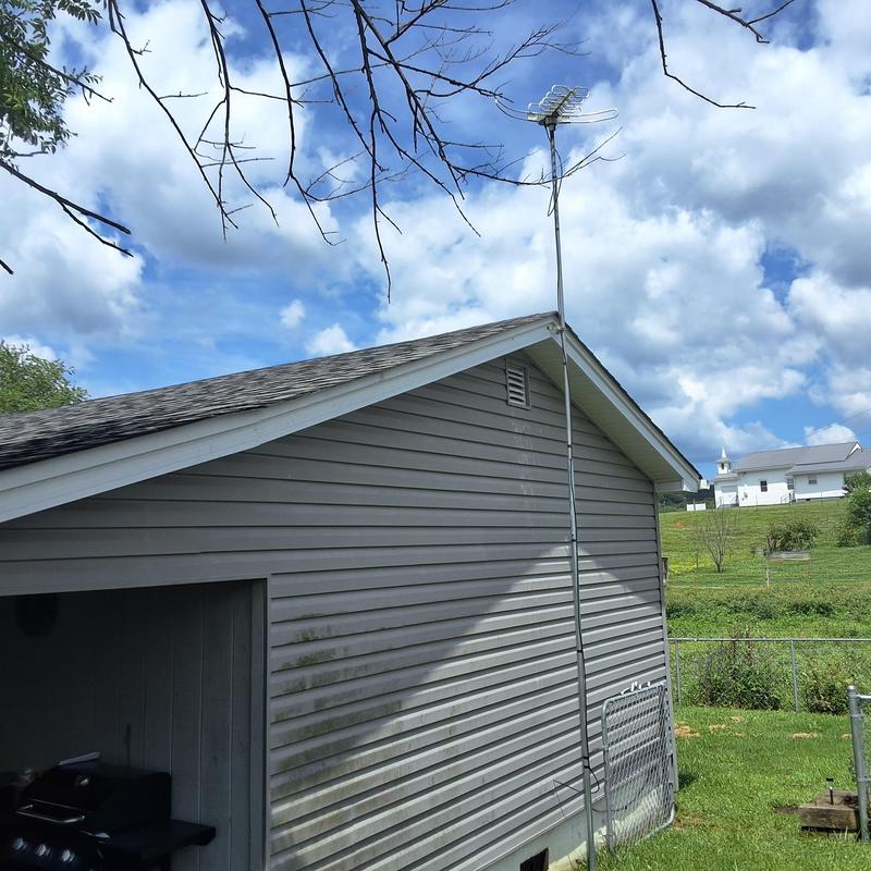 Shingle roof inspection with antenna on house side Shingle roof inspection with antenna on house side