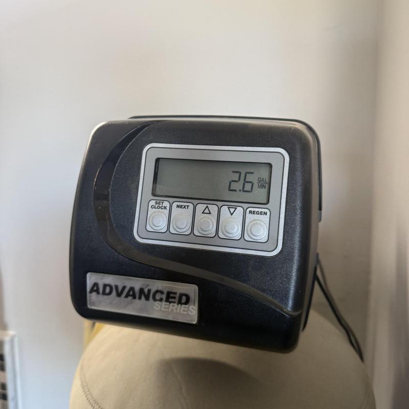 Water softener control valve display panel showing flow rate