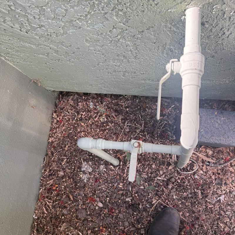 Exterior water shutoff valve with control handles and piping