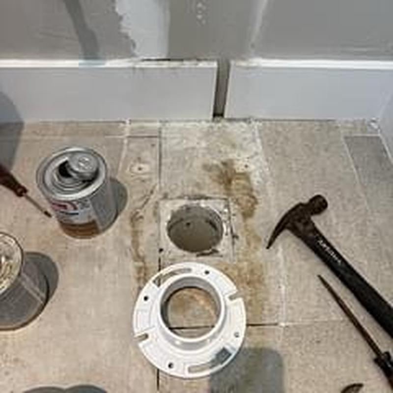Toilet flange installation with tools on tiled floor Toilet flange installation with tools on tiled floor