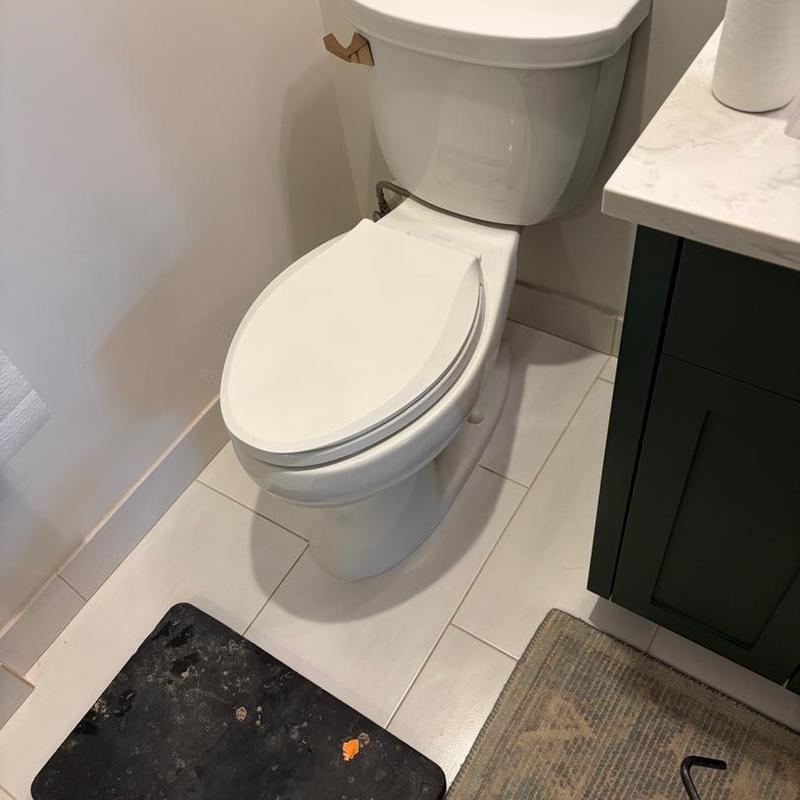Toilet base leak and reset in bathroom corner