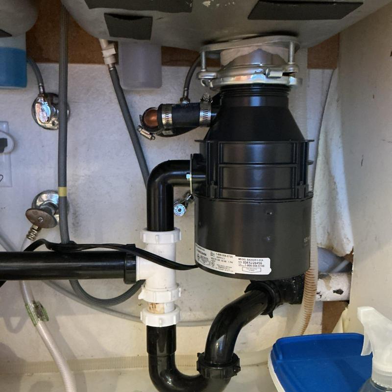 Garbage disposal unit with plumbing under sink