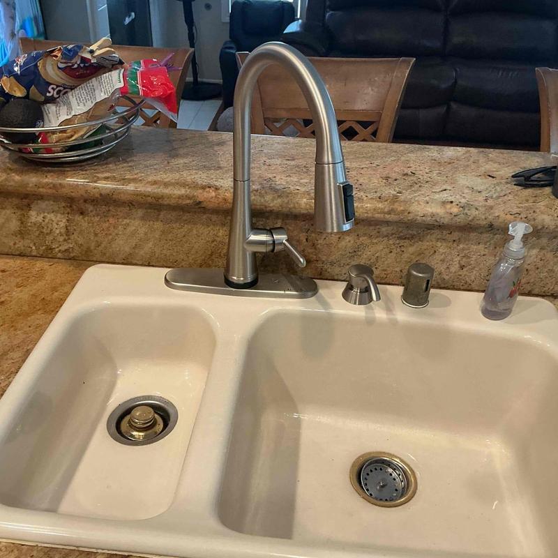 Kitchen sink faucet with pull-down sprayer installed
