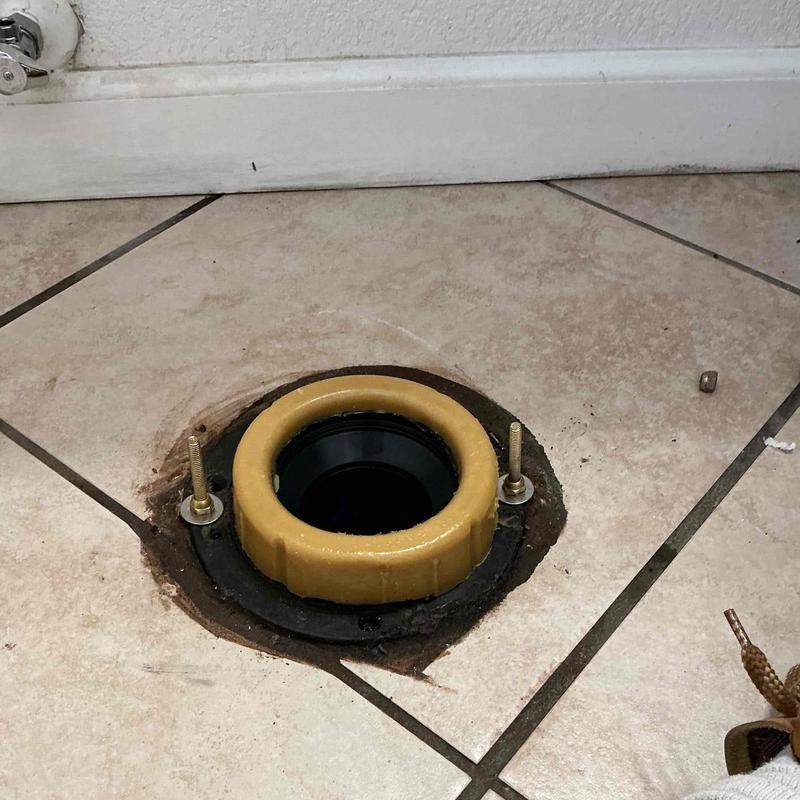 Toilet wax ring and flange on tiled floor