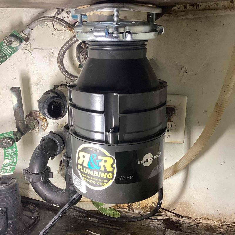 Garbage disposal unit under kitchen sink installation