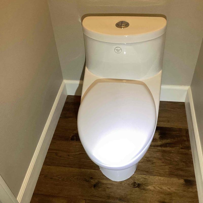 Skirted toilet installed on wood flooring