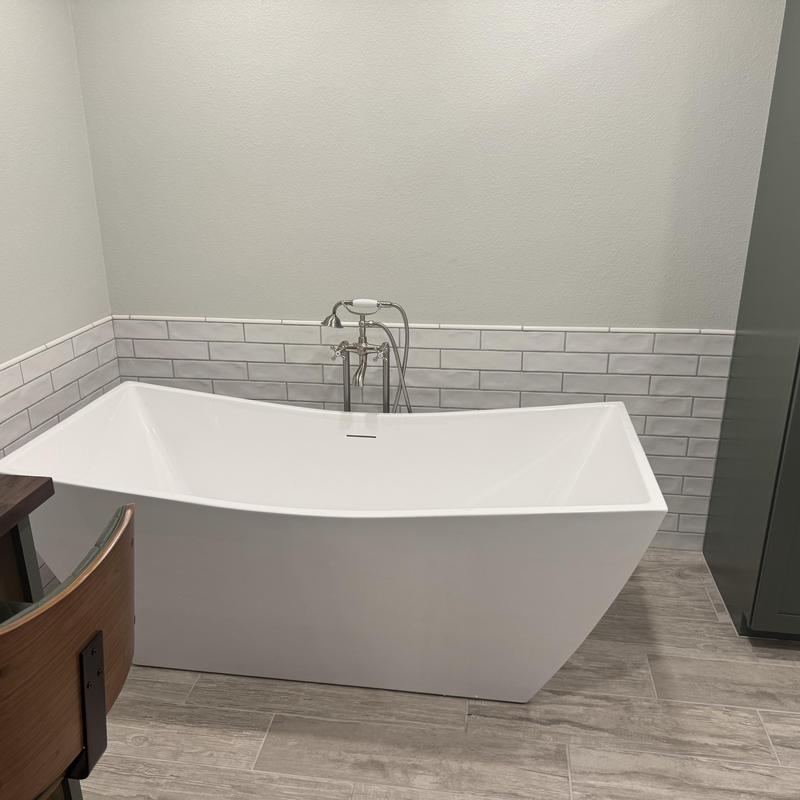 Freestanding bathtub with chrome faucet in bathroom