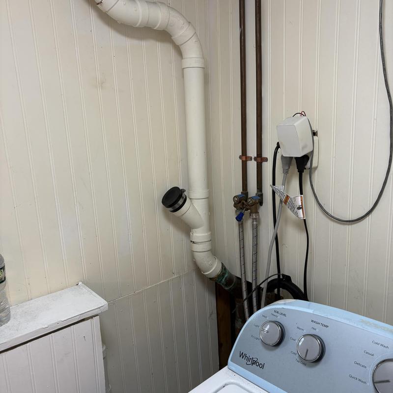 Open drain line and trap primer installation near washer Open drain line and trap primer installation near washer
