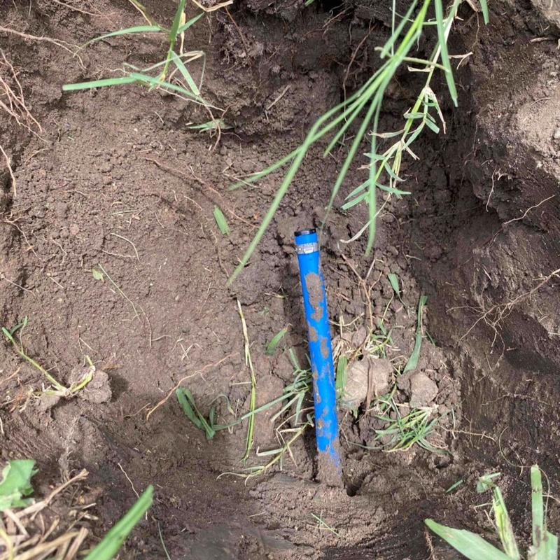 Blue capped hose bib buried in ground box