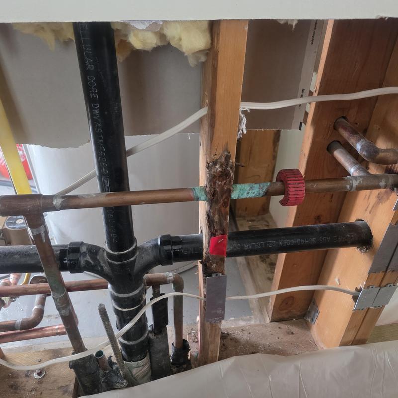 Copper water piping with corrosion damage and repairs