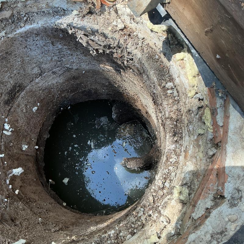 Septic tank opening with standing wastewater inside