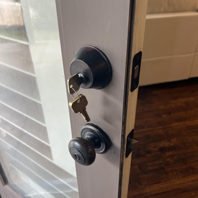 Deadbolt lock with keys in white house door