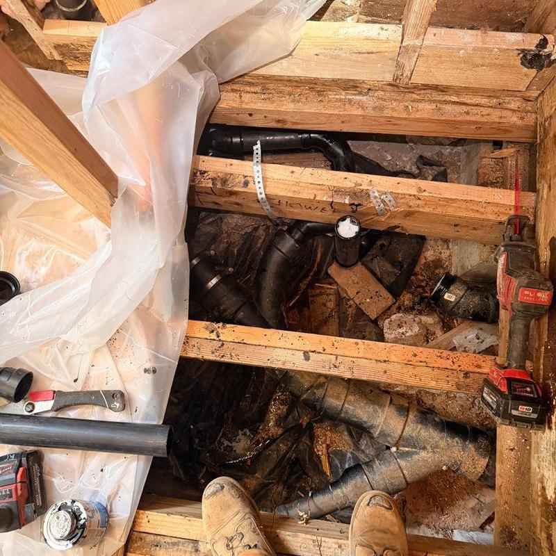 3-inch ABS drain line with fittings under floor joists 3-inch ABS drain line with fittings under floor joists