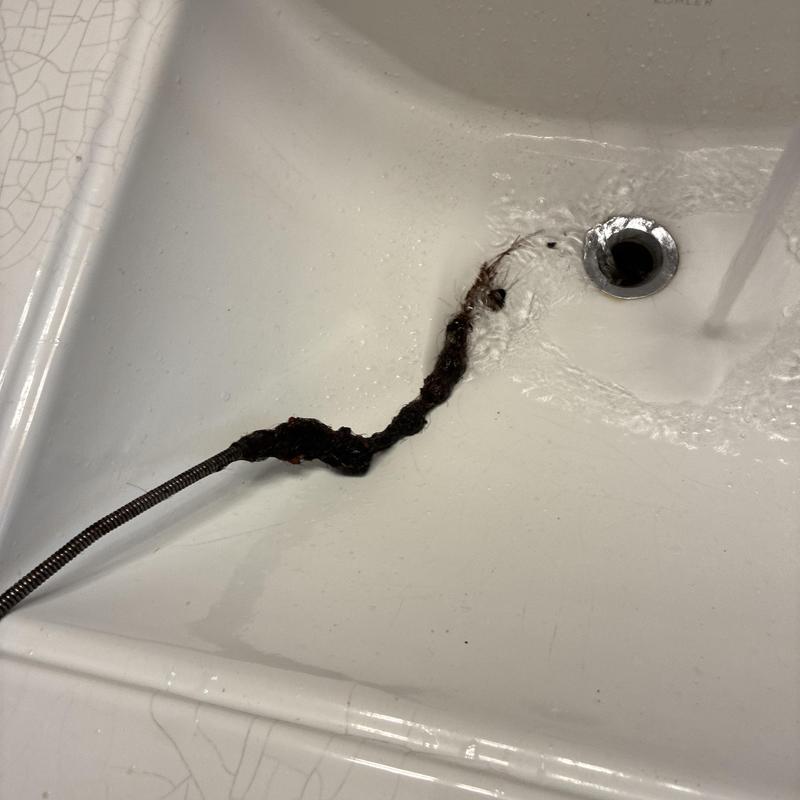 Basin drain clog removal with drain snake tool