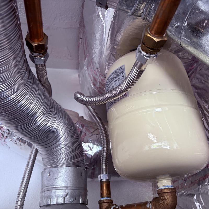 Water heater expansion tank with connected copper pipes