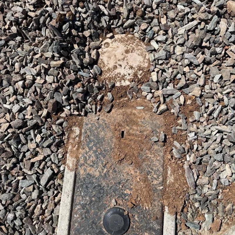Water main valve box with disturbed soil and gravel