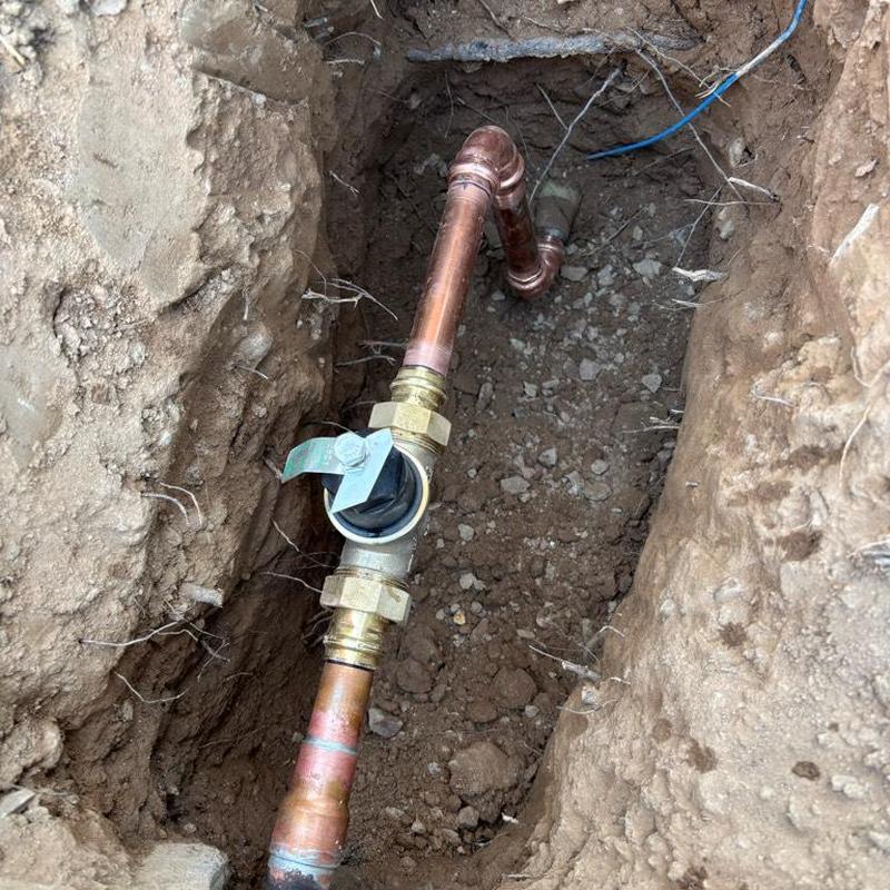 Pressure relief valve and copper piping in trench