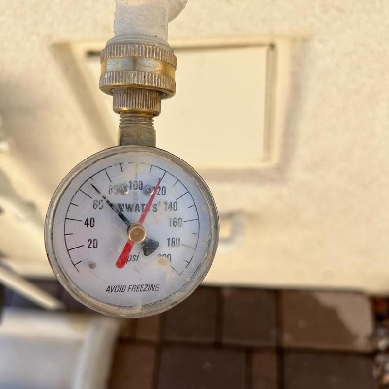 Pressure gauge on main waterline showing 68 PSI