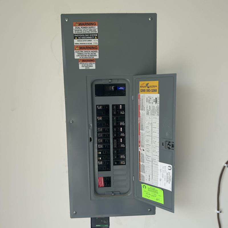 Electrical breaker panel with open service door in Boise, ID