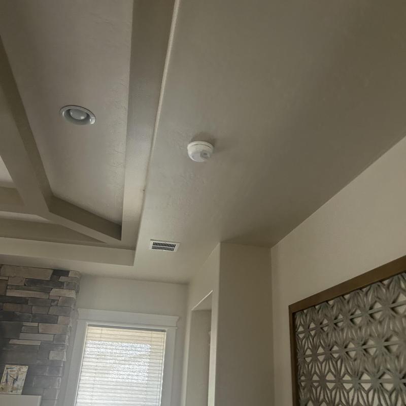 Smoke detector and light fixture installation on ceiling