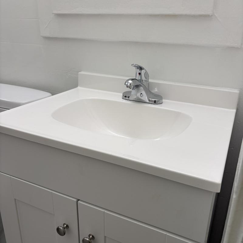 Bathroom vanity sink with faucet and cabinet installed