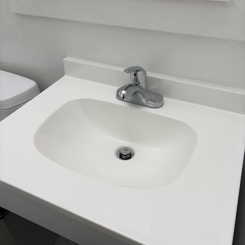 Bathroom vanity sink with faucet and drain installed
